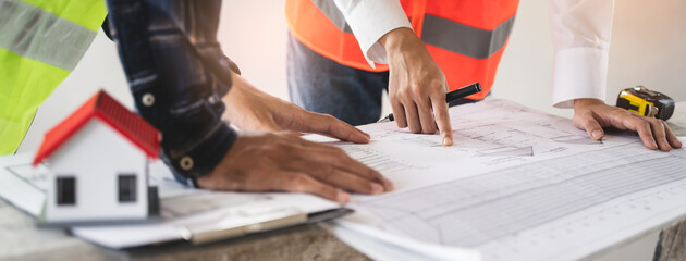 Concept Teamwork of building construction staff. Project engineer contractor reviewing plan of work...