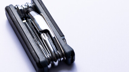 Black bicycle multifunctional multitool unfolded on a white background. Chrome steel tools. Tools...