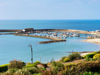 Harbour overview from Langmoor-Lister public gardens at Lyme Regis Dorset on a calm April morning
