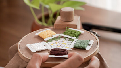 Vibrant Embroidery Palette: Colorful Floss Bobbins on Fabric with Hoop Frame