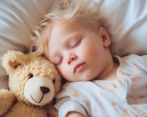 Blond child little boy sleeps like an angel in bed with a teddy bear