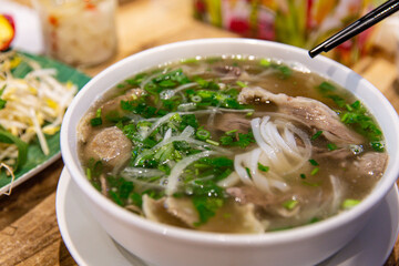 Pho Bo and Bo Vien Served Hot: A Perfect Blend of Vietnamese Noodles, Beef, and Meatballs with Fresh Herbs