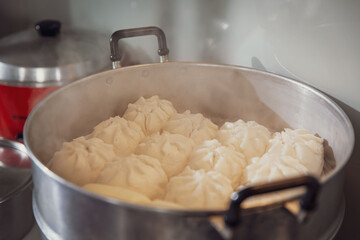 Steaming Hot Steamed Buns Fresh from the Stove, Ready to Serve in a Large Stainless Steel Steamer
