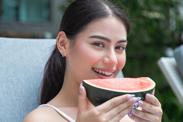 Beautiful Asian woman's mouth eating watermelon, orange, professional makeup