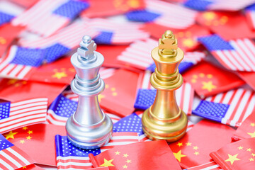 Two king chess games on US and Chinese flags indicate a trade war and trade tensions, a confrontation between two major countries in which the US imposes high tariff rates on Chinese exports.