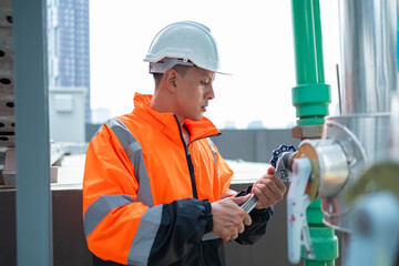 The engineer checks and adjusts the valve to allow the amount of water to flow through the CW bile...