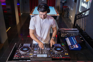 Smiling DJ Mixing Beats at Club Party