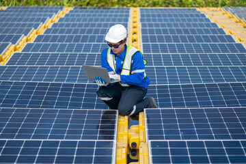 Solar Technician Monitoring Panels with Laptop