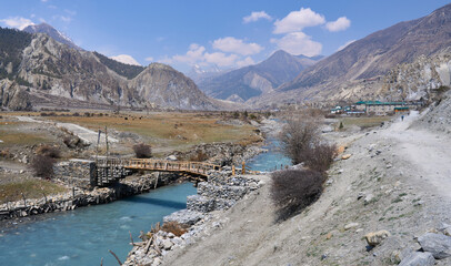 A new wooden bridge above the Marshyangdi River on the Annapurna Circuit Trek before the Braka...