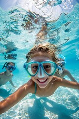 Fototapeta premium A wide-angle underwater photograph captures the joy of two children swimming and exploring in a large pool. Equipped with masks 