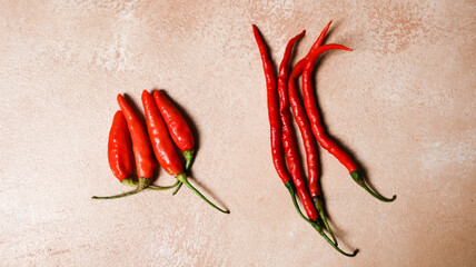 Two different types of red peppers are displayed side by side