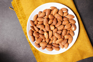 A bunch of almonds placed on a white plate