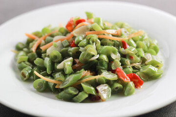 Sauteed Bean Vegetables on a white plate. Close up.