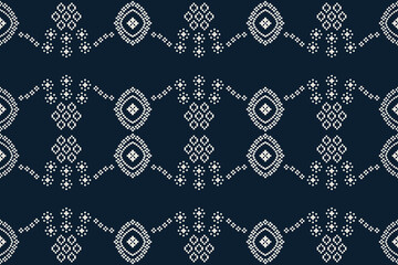 Traditional ethnic motifs ikat geometric fabric pattern cross stitch.Ikat embroidery Ethnic oriental Pixel navy blue background. Abstract,vector,illustration. Texture,decoration,wallpaper.