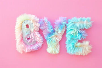 fluffy 'bye' text in vivid pastel colors on a gentle pink background for romantic designs