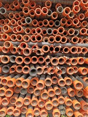 a pile of orange pipes with the words water supply on the bottom.