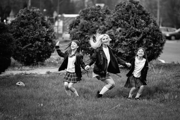 Portrait of a young mother and two beautiful daughters outdoors. Black and white photo.