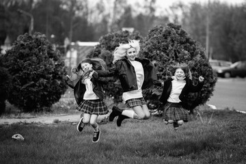 Portrait of a young mother and two beautiful daughters outdoors. Black and white photo.