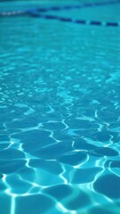 Obraz premium Close view of clear beautiful blue flowing water in swimming pool. Slow motion vertical video. Water surface. Travel and vacation concept. Summer