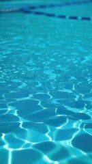 Close view of clear beautiful blue flowing water in swimming pool. Slow motion vertical video. Water surface. Travel and vacation concept. Summer