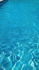 Close view of clear beautiful blue flowing water in swimming pool. Slow motion vertical video. Water surface. Travel and vacation concept. Summer