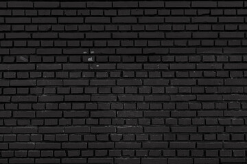 Old black brick wall. Abstract construction background.