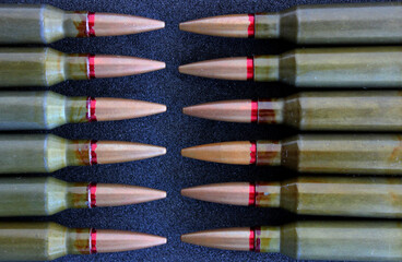 Pattern of live ammunition laid out bullet to bullet on a black background detailed stock photo