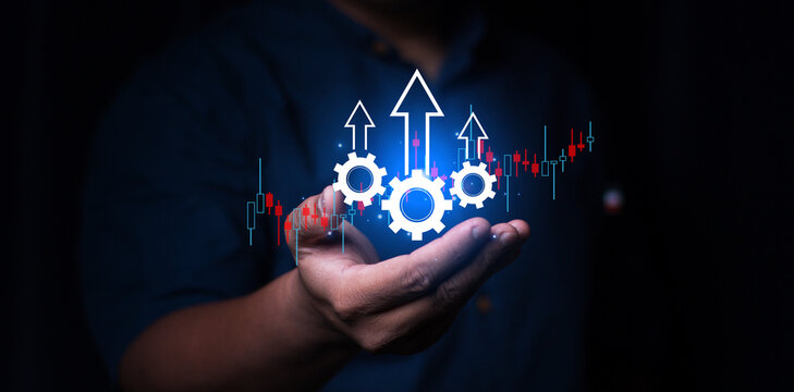 Process to increase productivity concept. Businessman holding productivity icon with growth graph for industrial management in efficiency and efficient process. Lean cost and productivity growth.