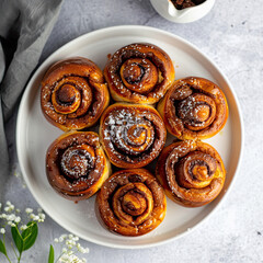 Fototapeta premium Top view of Cinnamon rolls buns on a white plate