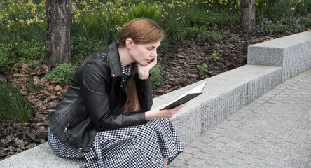 Girl reading a book in the park