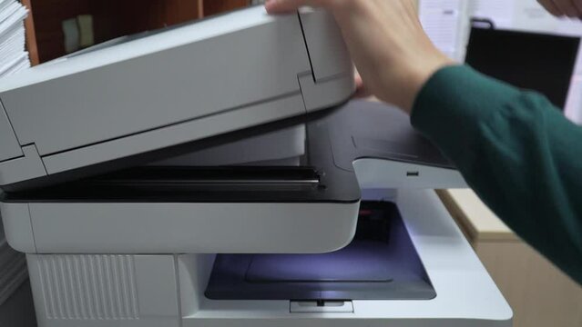 Unrecognizable Businessman's hands working in the office, making photocopies, using a touch screen printer
