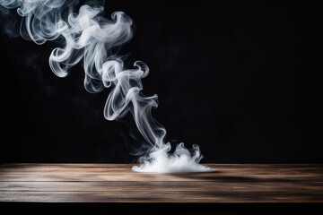 On a black background, an empty wooden table with smoke floats up. Empty space for displaying your products, with a smoke float up on a dark background.