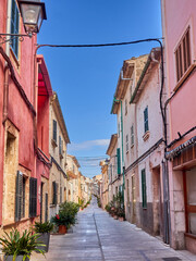 Picturesque alley with stone houses and plants in Alcudia, a touristic medieval town in the Mediterranean. Majorca, Balearic Islands, Spain, Europe