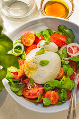 Burrata is a Apulian Italian cheese with a creamy base and a salad of  tomatoes. Summer Italian...