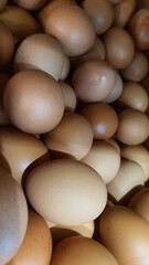Close up of  randomly stacked chicken eggs sold at the market as a background.