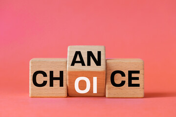 Symbol chance and choice and Flipped a wooden cube with words "Change choice" Beautiful pastel pink background, Business and chance and change concept. Copy space