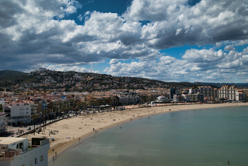 North beach of Peñiscola, with the promenade and the sky with clouds. Photograph taken from the Castle of Peñiscola.