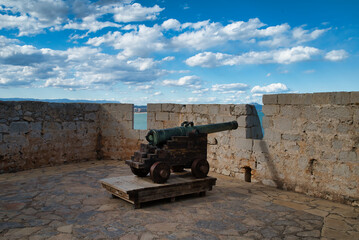  
Ancient medieval cannon placed on a defensive stone wall at the castle of Peñiscola, on the Costa Azahar of the Mediterranean Sea, Spain. 