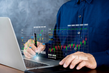 Trader use laptop analyzing growing stock on virtual screen for invest in trading.