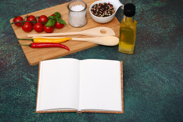 Opened blank notebook with vegetables and spices.
