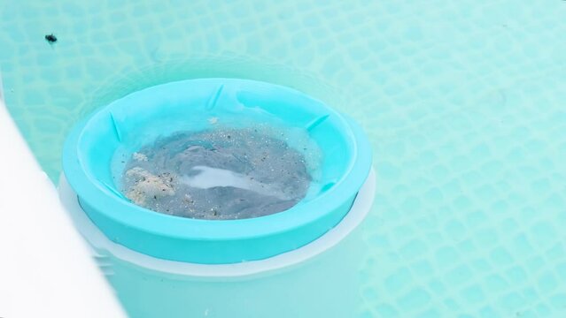 blue skimmer for cleaning the pool. Close-up of the skimmer mounted on a frame pool