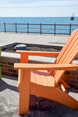 Colorful empty outdoor Adirondack chairs in along the city waterfront
