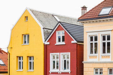Colorful houses stand out in a row of traditional buildings in old city in Bergen, Norway.