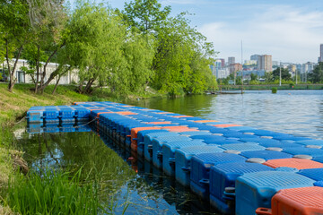 Floating pier made of composite plastic blocks on the river, sea. Plastic bridge on a lake