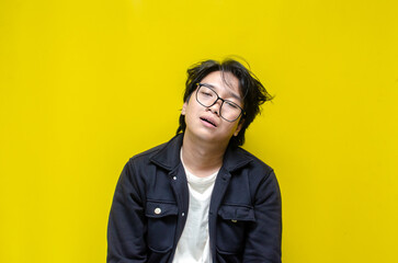 asian man looks depressed and messed up. Irritated man bites lips and scratches head. stressed over work concept.