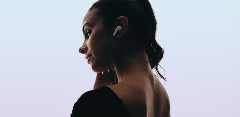 Woman enjoying peaceful moment with wireless earphones and a relaxing music playlist