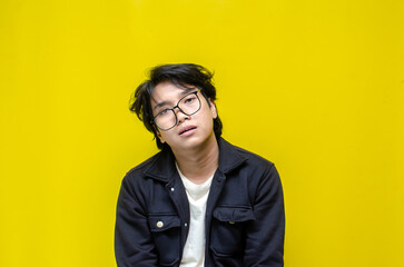 Fototapeta premium asian man looks depressed and messed up. Irritated man bites lips and scratches head. stressed over work concept.