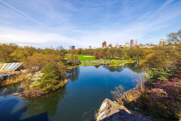 Beautiful view from the top of Belvedere Castle of the lake and green lawns with people relaxing in...