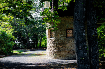 Madonnenschlössl in Bernstein Austria. Old stone wall in shadow of trees.