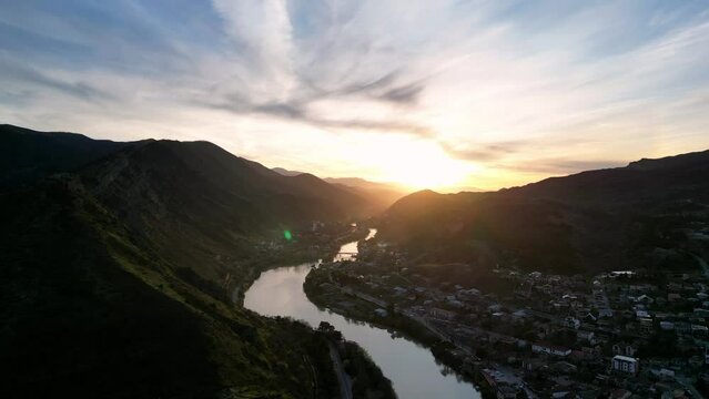 city of Mtskheta and the river at sunset, aerial view, village in the mountains
